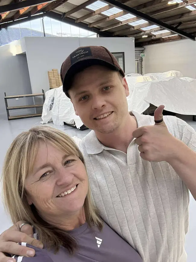 Two smiling people together in the Christchurch workshop